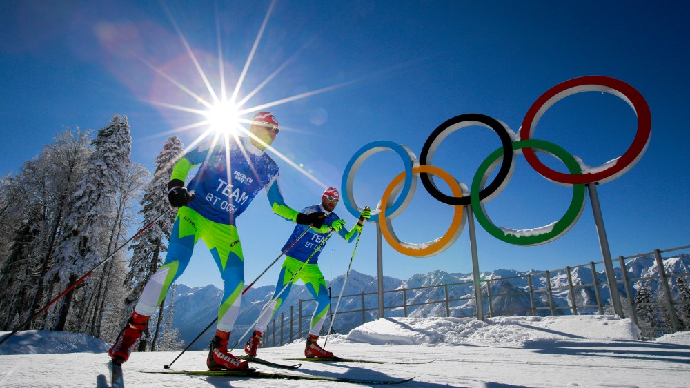 Members of the Slovenian Cross-country ski team ski in front of Olympic rings at Laura Cross-country Ski & Biathlon Center of the 2014 Winter Olympics, Feb. 2, 2014, in Krasnaya Polyana, Russia.