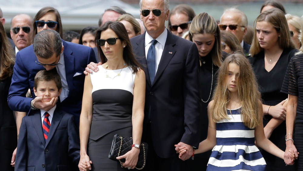 Hunter Biden, left, kisses his nephew Hunter, son of Beau Biden, as they stand with Beau's widow Hallie, Vice President Joe Biden, and Beau's daughter Natalie before his funeral, on June 6, 2015, in Wilmongton, Del. (Photo by Patrick Semansky/AP)