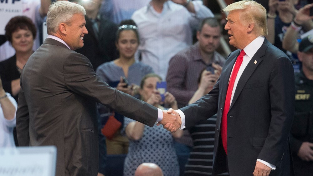 Buffalo Bills head coach Rex Ryan, left, shakes hands with Republican presidential candidate Donald Trump, after introducing him during a campaign stop at the First Niagara Center, April 18, 2016, in Buffalo, N.Y. (Photo by John Minchillo/AP)