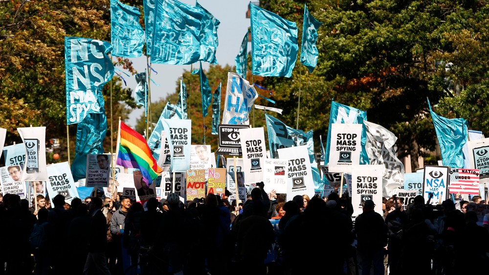 Demonstrators march through Washington towards the U.S. Capitol to rally and demand that the U.S. Congress investigate the National Security Agency's mass surveillance programs Saturday, Oct. 26, 2013.