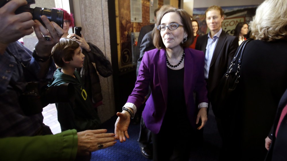 Oregon Secretary of State Kate Brown greets people during a celebration at the Oregon Historical Society to mark the 156th anniversary of Oregon's admission to the union as the 33rd state in Portland, Ore., Feb. 14, 2015. (Photo by Don Ryan/AP)