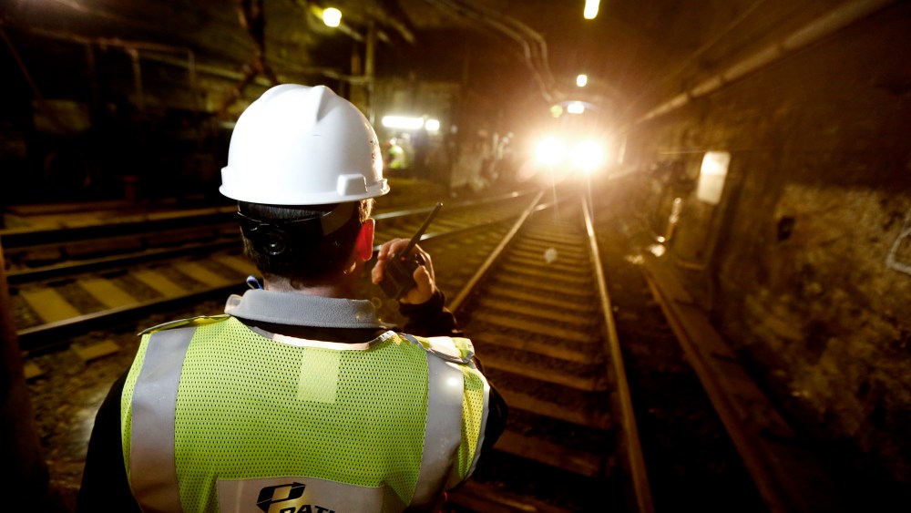A Port Authority work on the Trans-Hudson train line, talks on a radio as a PATH train approaches in the tunnel, on Nov. 27, 2012, in Hoboken, N.J.