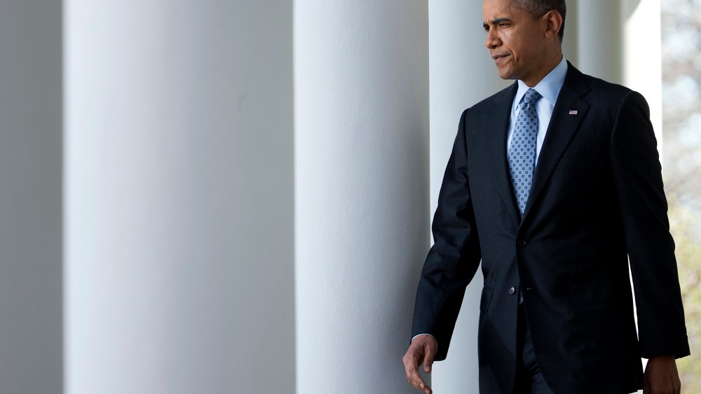 President Barack Obama walks from the Oval Office to the Rose Garden of the White House in Washington, April 1, 2014.