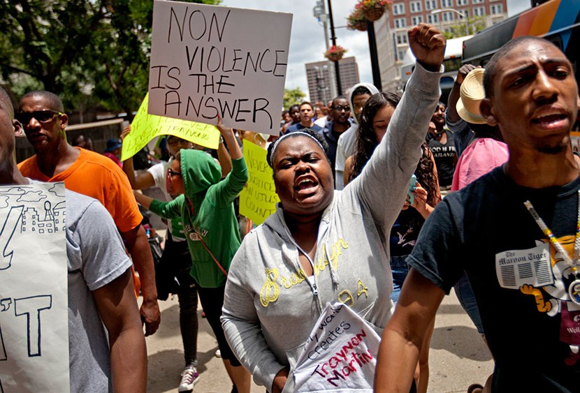 Lisa Archer, 24, of Atlanta, center, chants as protestors march, Sunday, July 14, 2013, in Atlanta the day after George Zimmerman was found not guilty in the 2012 shooting death of teenager Trayvon Martin.   (Photo by David Goldman/AP)