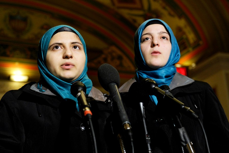 Heba Sawwan, left, and her cousin Ameenah Sawwan, right, survivors of the August 2013 chemical weapons attack in Syria, speak during a news conference in Washington, Feb. 6, 2014.
