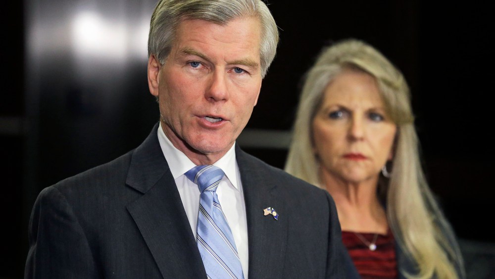 Former Virginia Gov. Bob McDonnell makes a statement as his wife, Maureen, listens during a news conference in Richmond, Va., Jan. 21, 2014.