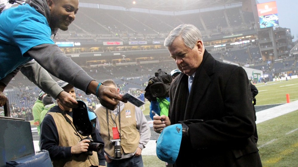 Carolina Panthers owner Jerry Richardson signs an autograph for a fan before an NFL Divisional Playoff game against the Seattle Seahawks on Jan. 10, 2015 at CenturyLink Field. (Photo by Kevin Terrell/AP)