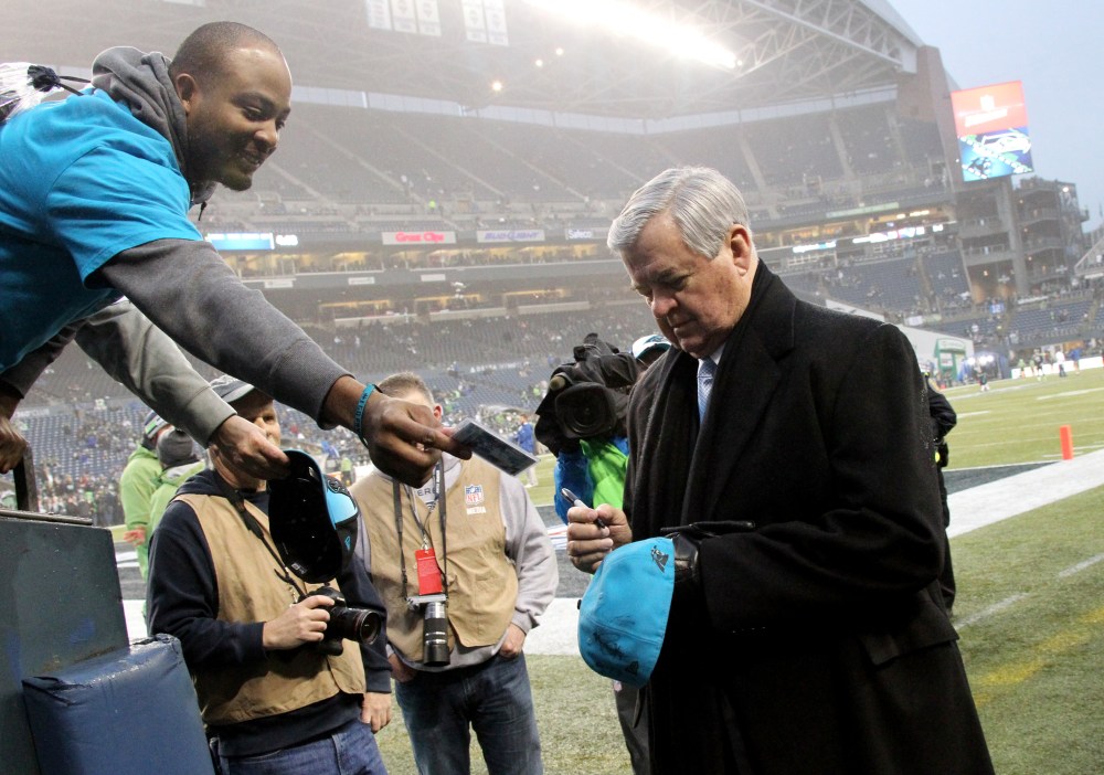 Carolina Panthers owner Jerry Richardson signs an autograph for a fan before an NFL Divisional Playoff game against the Seattle Seahawks on Jan. 10, 2015 at CenturyLink Field. (Photo by Kevin Terrell/AP)