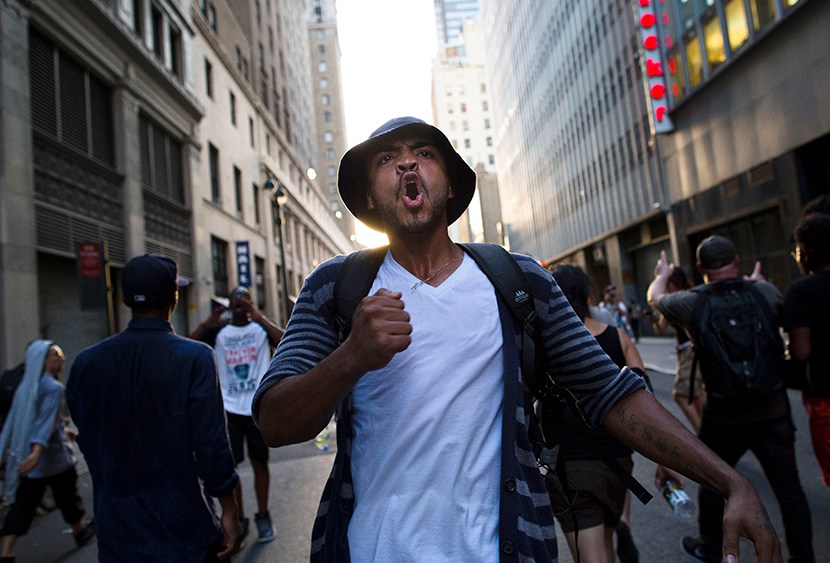 A demonstrator chants, Sunday, July 14, 2013, in New York, during a march against the acquittal of neighborhood watch member George Zimmerman in the killing of 17-year-old Trayvon Martin in Florida.  (Photo by John Minchillo/AP)
