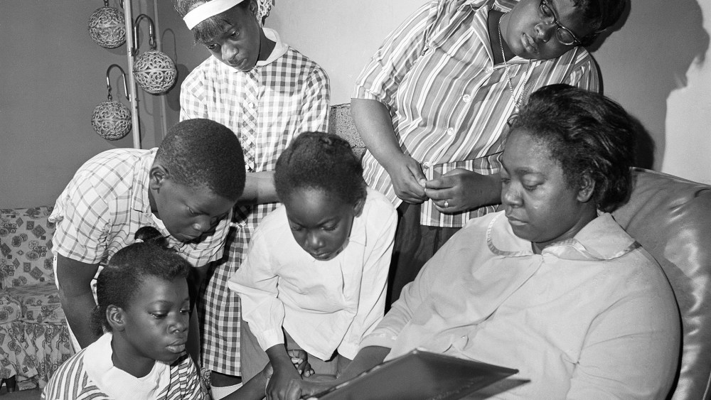 Exerlena Jackson, widow of Wharlest Jackson, ex-treasurer of the Natchez NAACP, who was killed by a bomb blast in his pickup truck, is shown with her family. (Photo by AP)