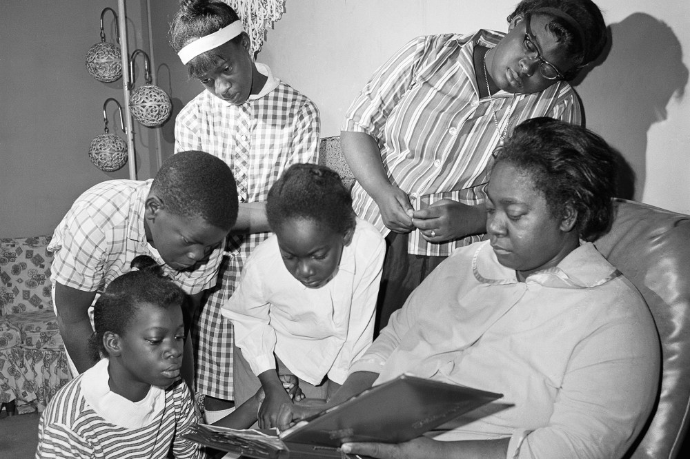 Exerlena Jackson, widow of Wharlest Jackson, ex-treasurer of the Natchez NAACP, who was killed by a bomb blast in his pickup truck, is shown with her family. (Photo by AP)