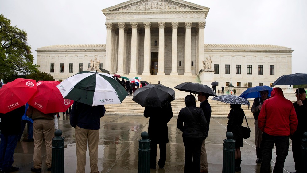 People line up outside the Supreme Court to listen to arguments, April 29, 2014, in Washington.