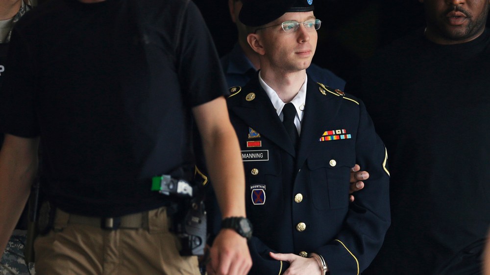 Chelsea Manning is escorted out of a courthouse in Fort Meade, Md., July 30, 2013.