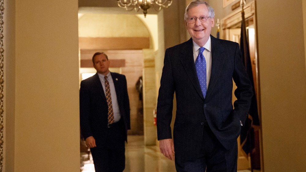 Senate Minority Leader Mitch McConnell of Ky. smiles as he arrives for a meeting of Senate Republicans on Nov. 13, 2014. (J. Scott Applewhite/AP)