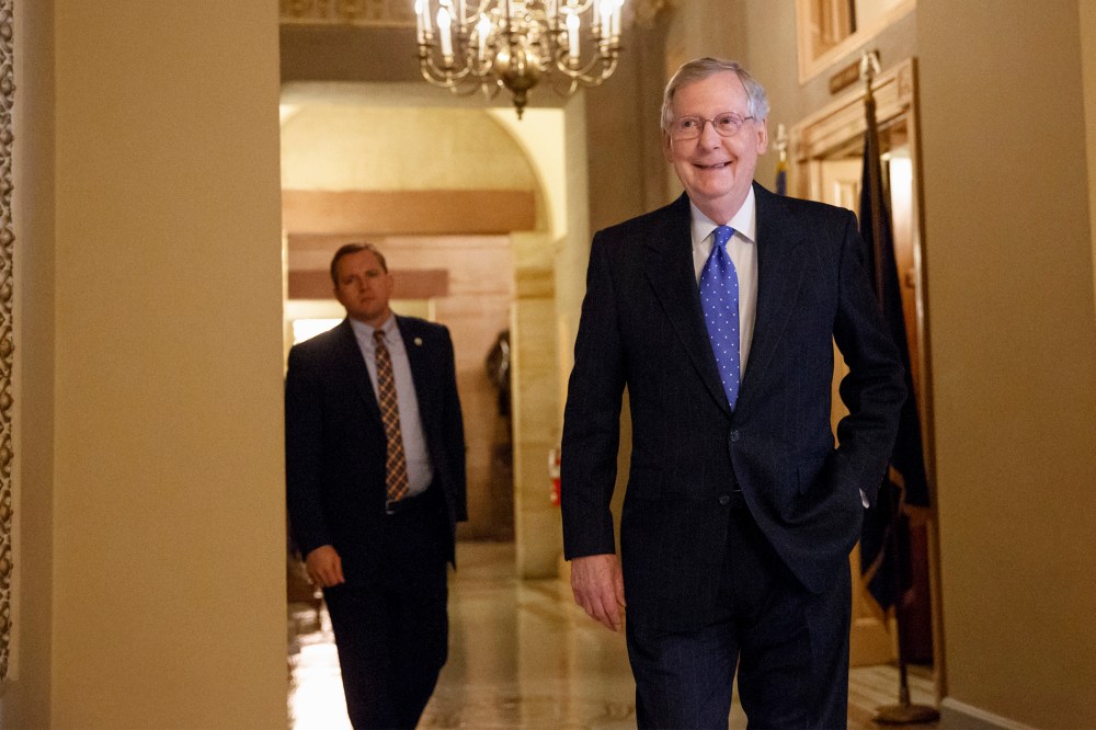 Senate Minority Leader Mitch McConnell of Ky. smiles as he arrives for a meeting of Senate Republicans on Nov. 13, 2014. (J. Scott Applewhite/AP)