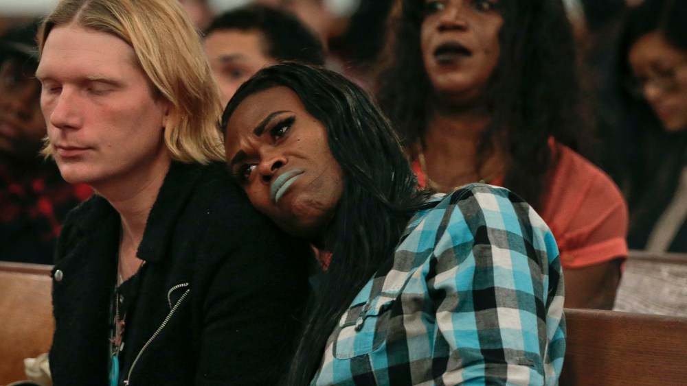 A couple attending a Trans Day of Remembrance program listen during a speech about violence against transgender people, in New York, Nov. 18, 2015. (Photo by Julie Jacobson/AP)