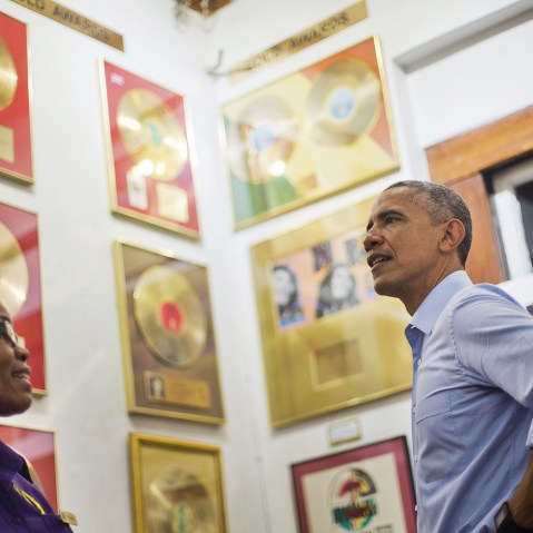U.S. President Barack Obama, right, visits the Bob Marley Museum with tour guide Natasha Clark, left, April 8, 2015 in Kingston, Jamaica.