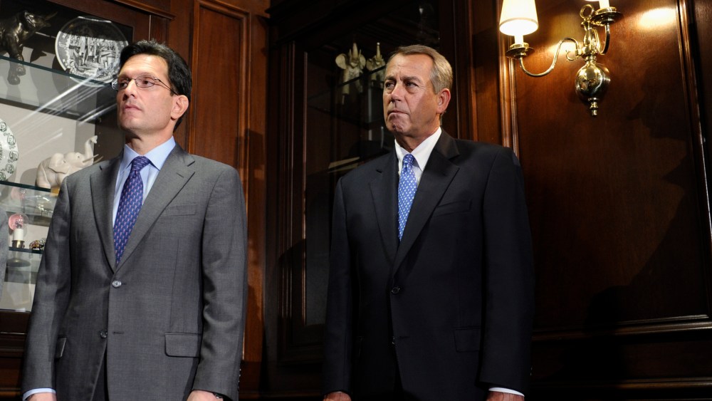 House Speaker John Boehner of Ohio, center, and House Majority Leader Eric Canton of Va., left, listen during a news conference after a meeting at the Republican National Committee offices