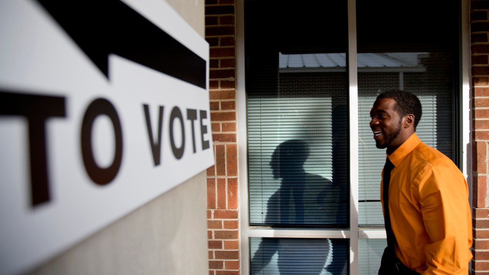 Jovan Steele, of Atlanta, enters a polling station to vote, Tuesday, Nov. 5, 2013.