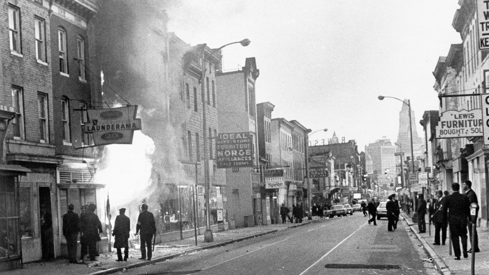 Fire shoots out from a Baltimore store on Gay Street as looting erupted in a five-block business section in Baltimore on April 6, 1968.