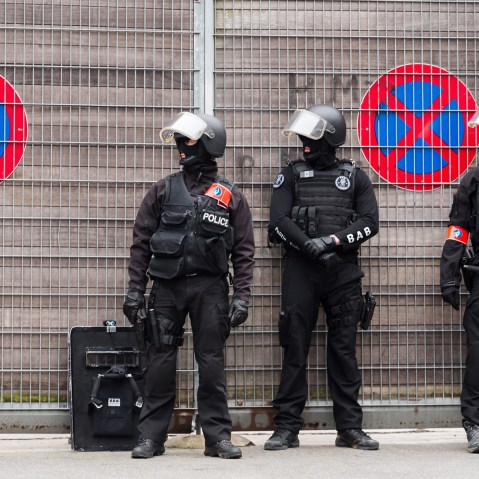 Police stand guard during a raid in the Molenbeek neighborhood of Brussels, Belgium, March 18, 2016. Police have descended in force to search a residence believed to be the location of terror suspect Salah Adeslam. (Photo by Geert Vanden Wijngaert/AP)