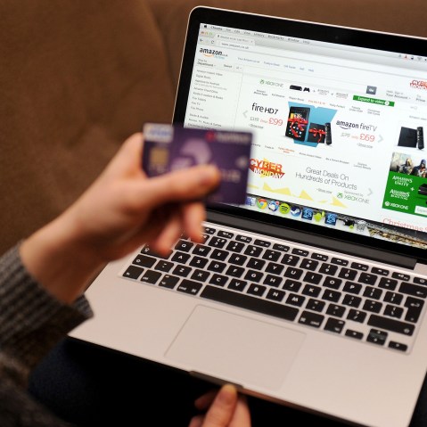 A woman using a laptop to shop Cyber Monday sales on the Amazon website. (Photo by Tim Goode/PA Wire/AP)