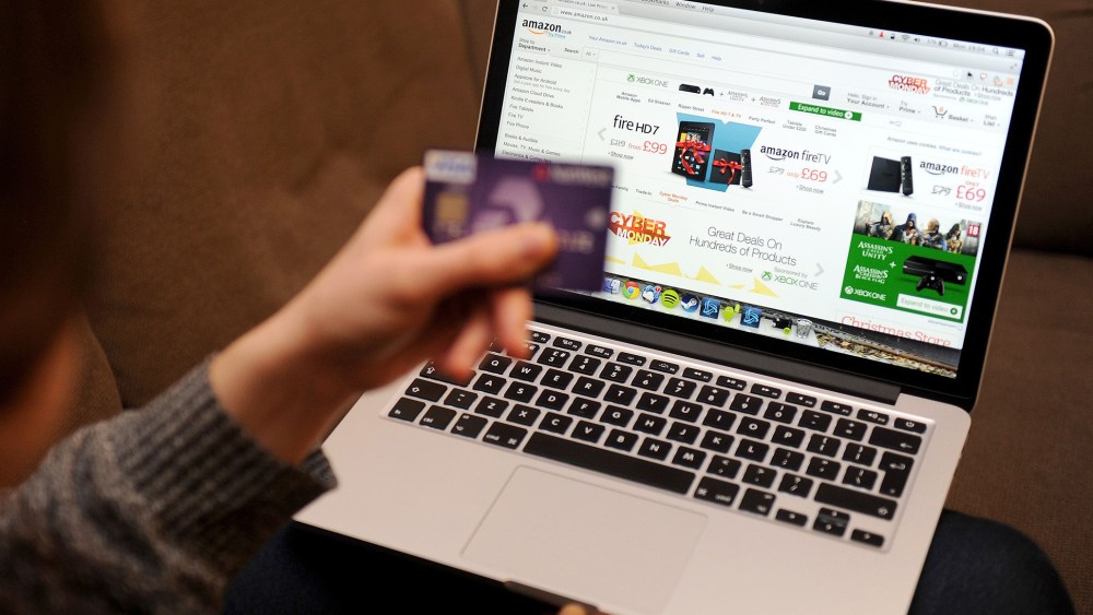 A woman using a laptop to shop Cyber Monday sales on the Amazon website. (Photo by Tim Goode/PA Wire/AP)