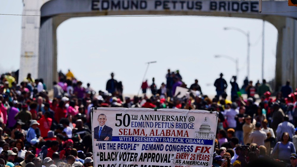 Crowds take a symbolic walk across the Edmund Pettus Bridge on March 8, 2015, in Selma, Ala. (Photo by Bill Frakes/AP)