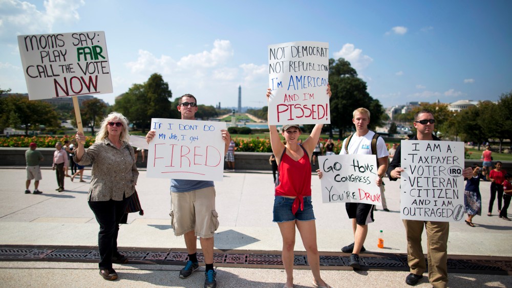 Protestors holds signs against the government shutdown on the West Front of the U.S. Capitol building on Capitol Hill on Friday, Oct. 4, 2013 in Washington.