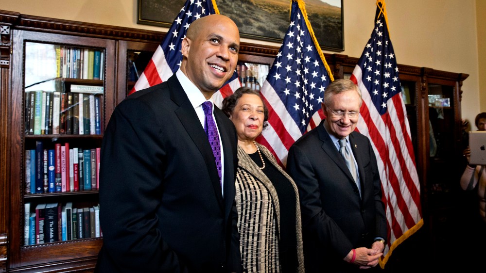 Newly-elected Democratic senator from New Jersey, former Newark Mayor Cory Booker, left, and his mother, Carolyn Booker, meet with Senate Majority Leader Harry Reid of Nev., before being officially sworn in on the floor of the Senate, Thursday, Oct. 31, 2