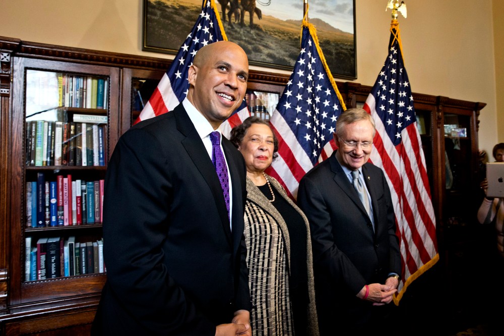 Newly-elected Democratic senator from New Jersey, former Newark Mayor Cory Booker, left, and his mother, Carolyn Booker, meet with Senate Majority Leader Harry Reid of Nev., before being officially sworn in on the floor of the Senate, Thursday, Oct. 31, 2