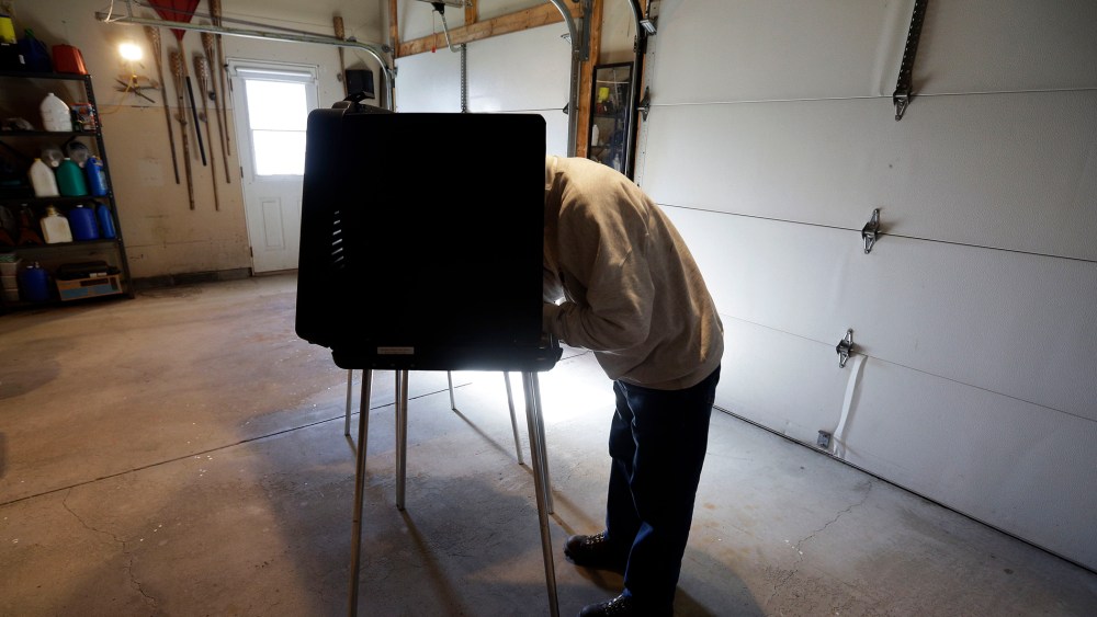 A man casts his vote at a polling place inside a residential garage, Nov. 6, 2012, in Forest City, Pa.