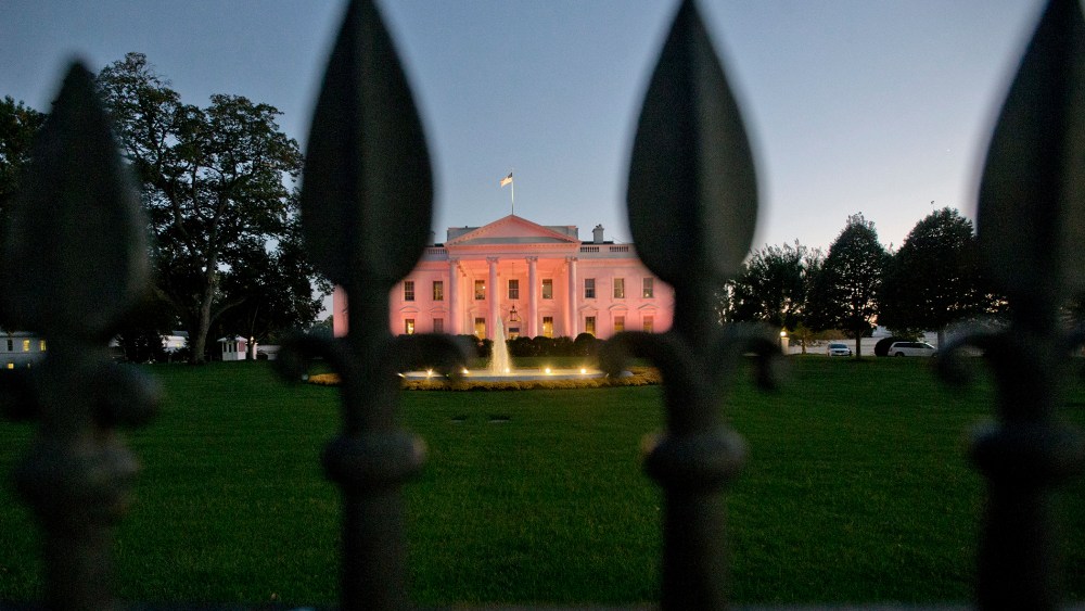 The White House in Washington is bathed in pink light on Oct. 24, 2013.