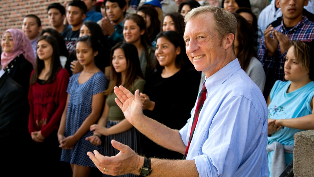 California Prop. 39 co-chair Tom Steyer takes photos with students at John Marshall High School in Los Angeles, Oct. 28, 2014. (Photo by Damian Dovarganes/AP)