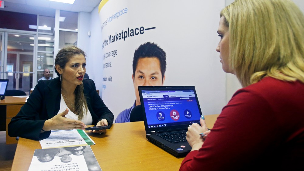 Johanna Diaz, left, talks to Senior Certified Enrollment Specialist Marlene Nesmith, right, at a  Healthcare Marketplace office in Miami, Dec. 20, 2013.