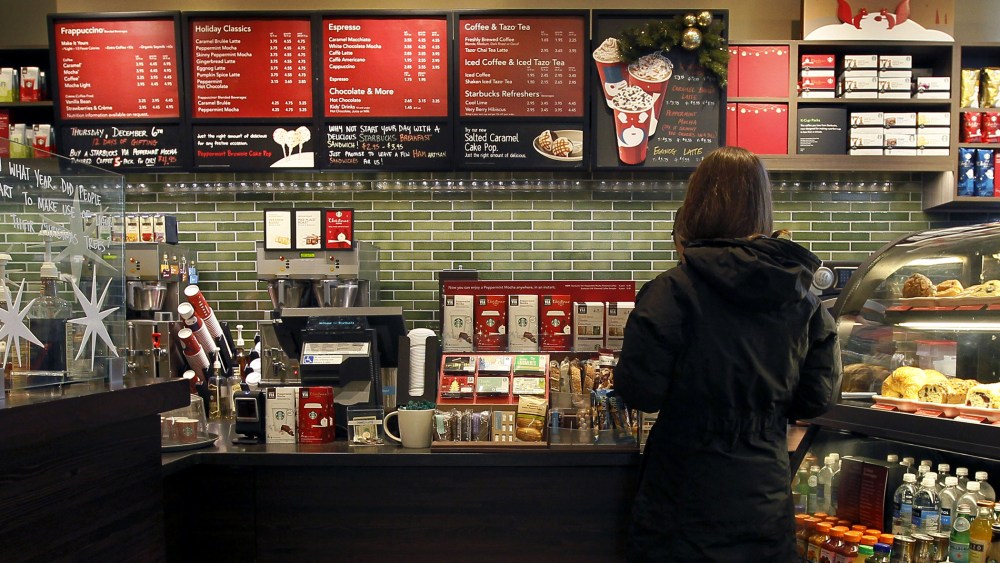 A Starbucks customer orders at a Chicago area store, Dec. 5, 2012. (Photo by Charles Rex Arbogast/AP)