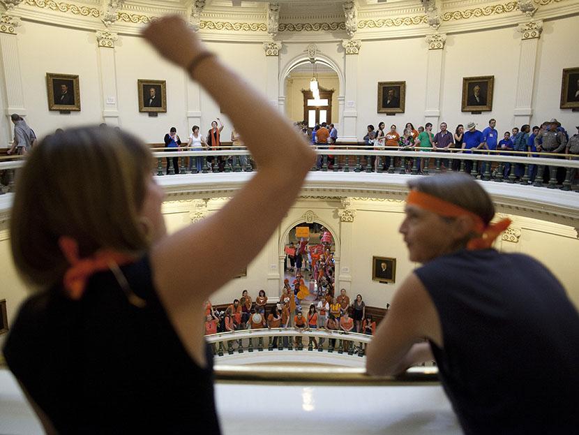 Hallie Boas and Lisa Fithian lead abortion rights chants from the third floor of the Texas Capitol Rotunda in Austin, Texas on Friday, July 12, 2013. (Photo by Tamir Kalifa/AP)