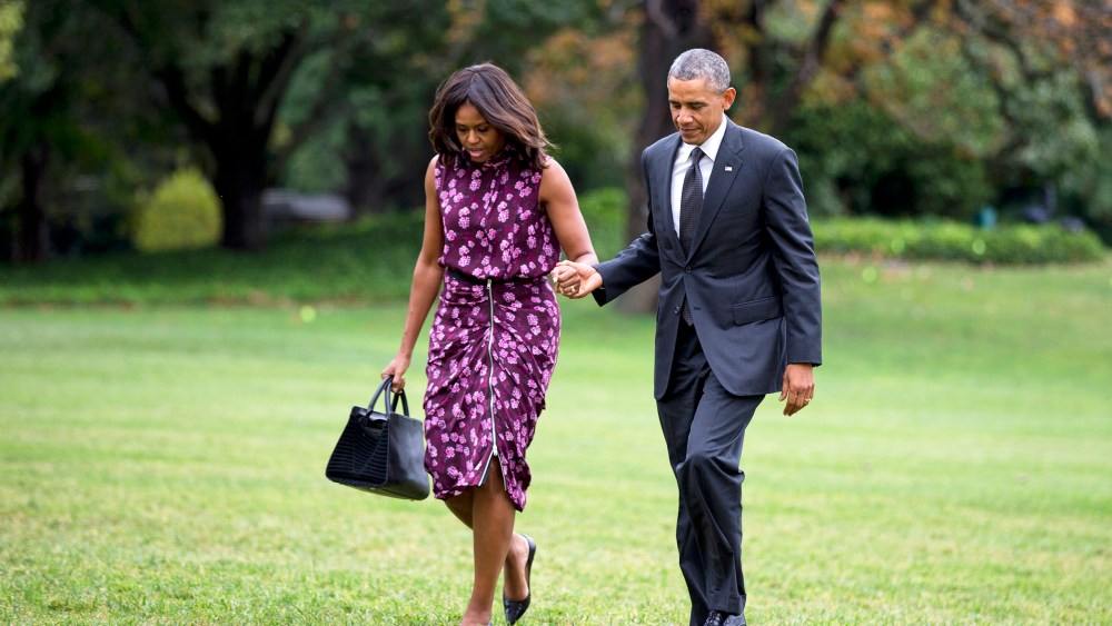 President Barack Obama and first lady Michelle Obama walk on the South Lawn of the White House in Washington, D.C., Sept. 25, 2014. (Photo by Manuel Balce Ceneta/AP)