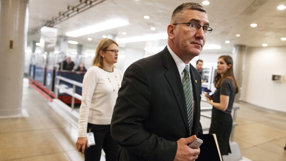 Sen. John Walsh walks to the Senate chamber on Capitol Hill in Washington, Feb. 12, 2014.