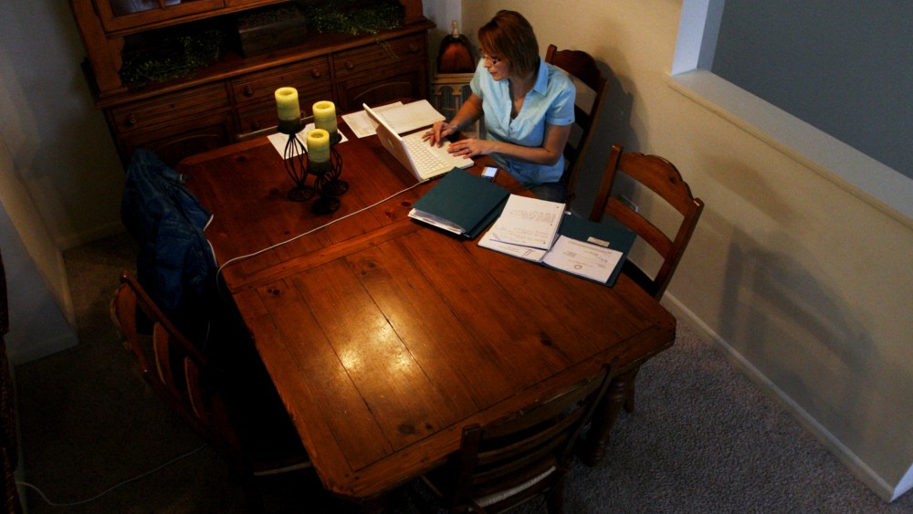 Debbie Jurcak, a mother of three, works on an application for state aid at her apartment in Aurora, Ill. Jurcak, 43, was among many Americans who lost unemployment benefits in late December.