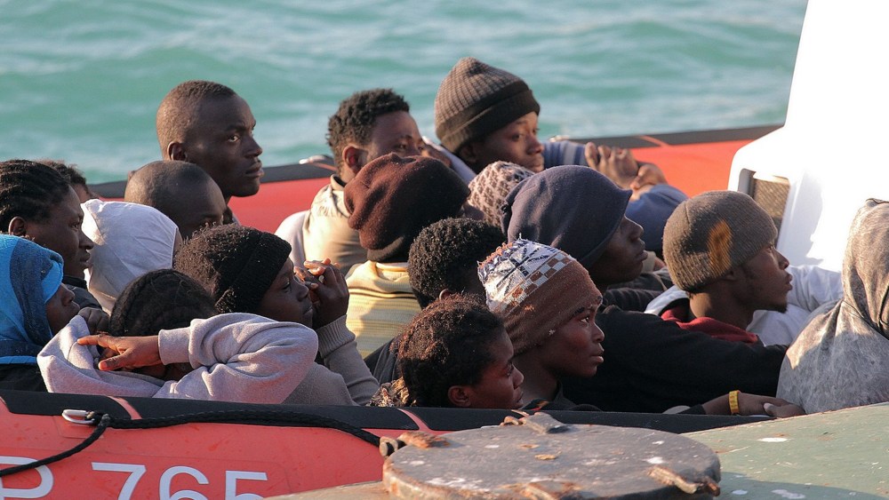 Migrants on a Coast Guard dinghy boat arrive at the Sicilian Porto Empedocle harbor, Italy, Monday, April 13, 2015. Italy's Coast Guard helped save 144 migrants Monday from a capsized boat in the waters off Libya. (Photo by Calogero Montanalampo/AP)