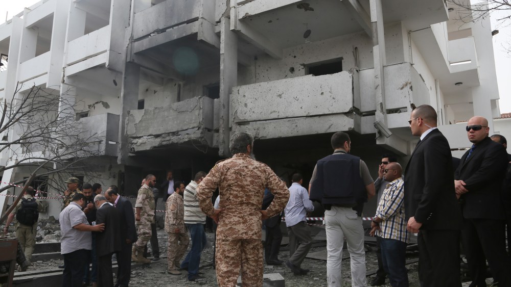 Security officers and officials inspect the site of a car bomb that targeted the French embassy wounding two French guards and causing extensive material damage in Tripoli, Libya, Tuesday, April 23, 2013. (Photo by Abdul Majeed Forjani/AP Photo)
