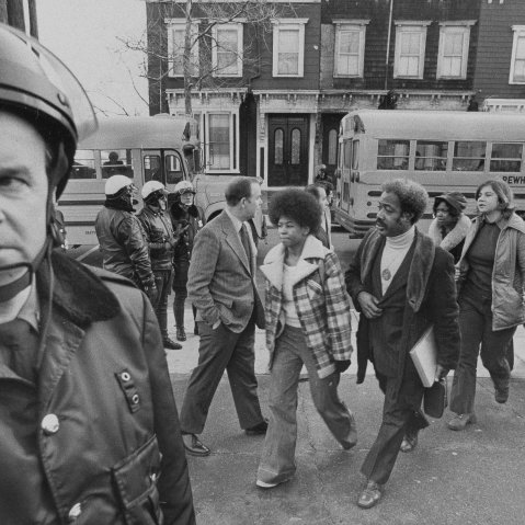 Buses arrive at South Boston High School, Jan. 8, 1975 as classes resume at the racially troubled institution. Police were on hand to provide protection as black students arrived. (AP Photo)