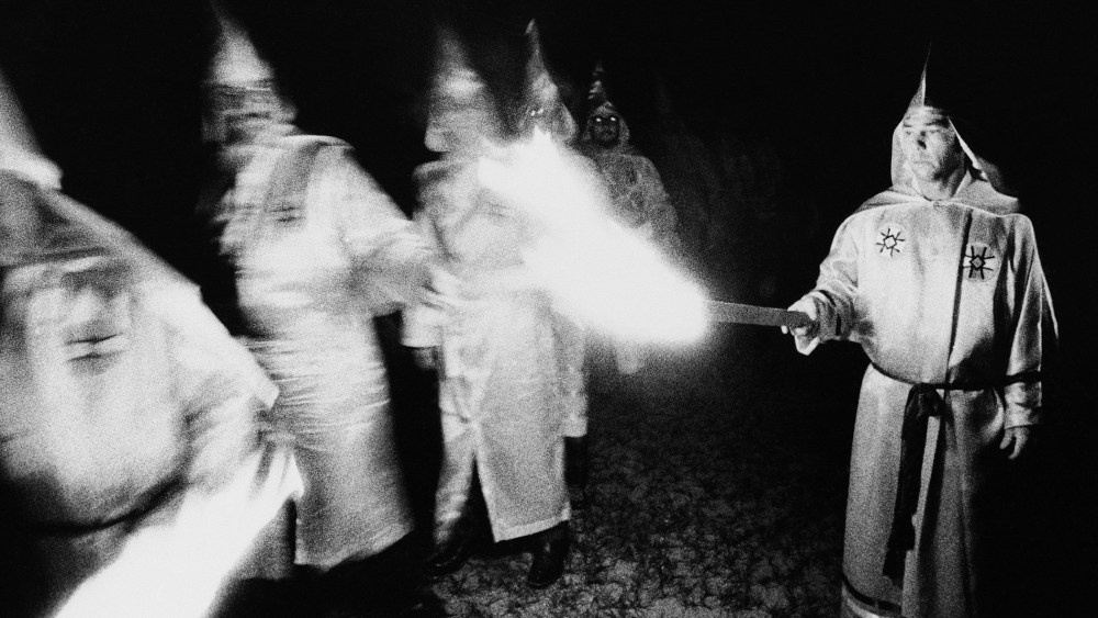 Ku Klux Klan members light their torches during a membership rally in Pensacola, Florida, May 25, 1975.