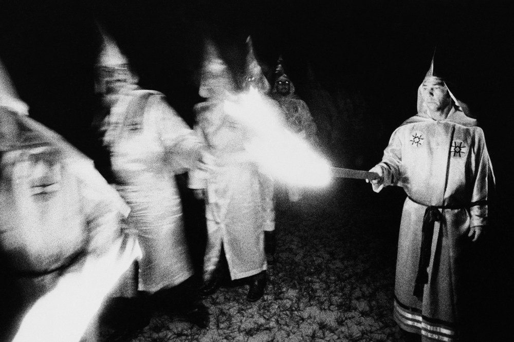 Ku Klux Klan members light their torches during a membership rally in Pensacola, Florida, May 25, 1975.