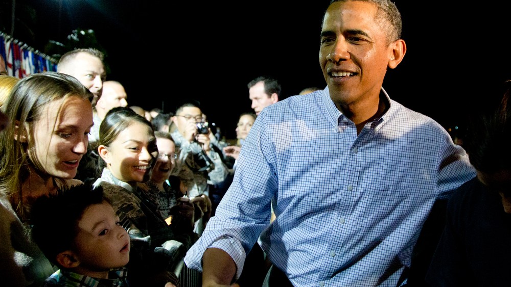 President Barack Obama greets people on the tarmac before boarding Air Force One in Honolulu, Jan. 4, 2014.