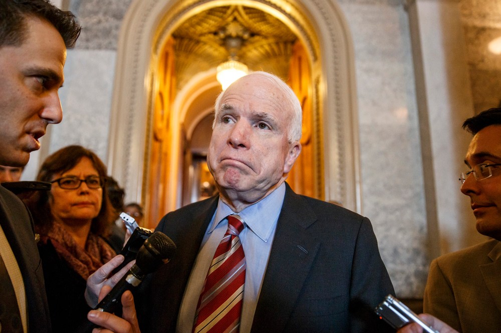 Sen. John McCain leaves the Senate chamber, March 5, 2014.