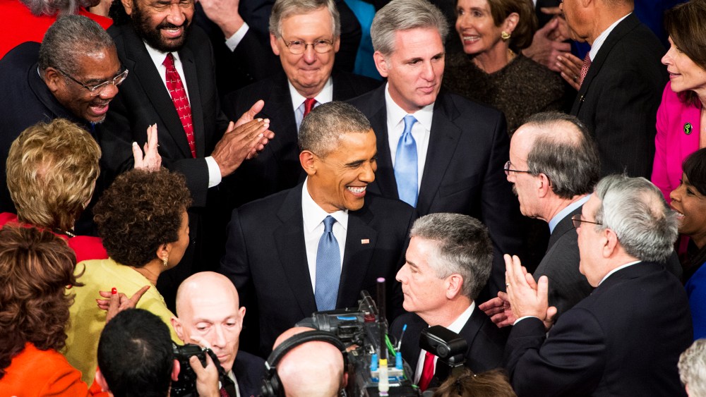 President Barack Obama greets members of Congress as he arrives in the House chamber in the U.S. Capitol to deliver his State of the Union address on Jan. 20, 2015. (Photo By Bill Clark/CQ Roll Call/AP)