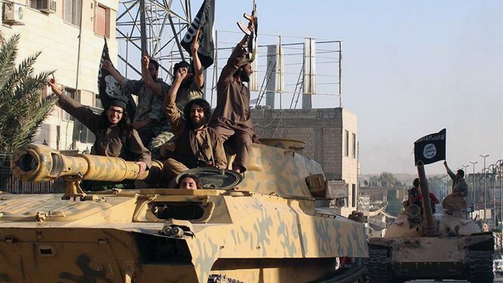 Fighters from the al-Qaida-linked Islamic State group parade in Raqqa, Syria on June 30, 2014. (Photo by Raqqa Media Center of the Islamic State Group/AP)