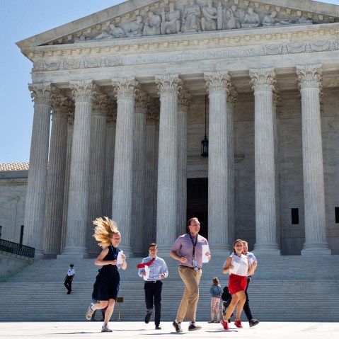 New interns run with a decision across the plaza of the Supreme Court in Washington, June 29, 2015. (Photo by Jacquelyn Martin/AP)